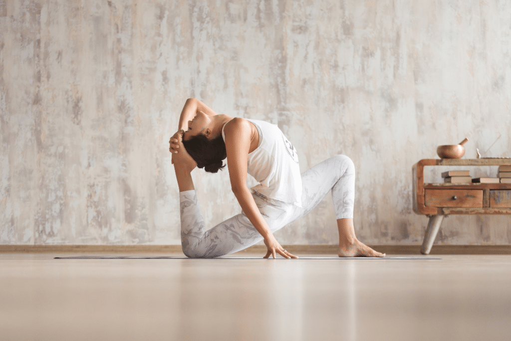 A woman doing a yoga pose in a room.