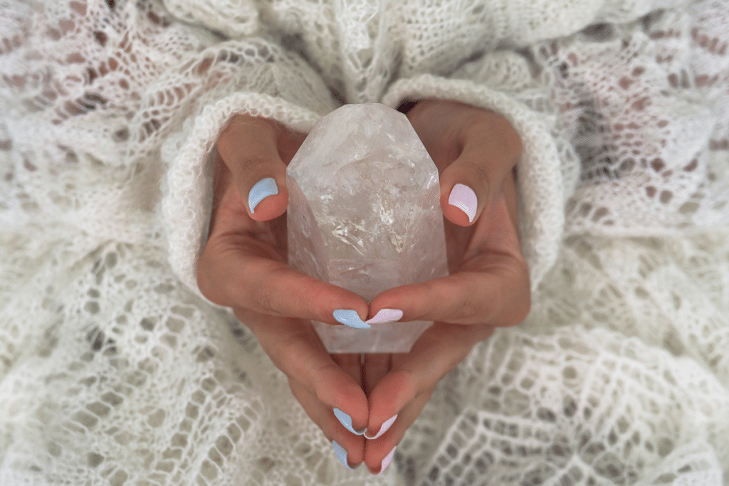 A woman holding a quartz crystal in her hands.