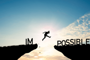 A man jumping over a cliff with the words i'm possible.